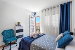 a bedroom with a bed and a chair and a window at Casa Brisas De Candelaria in Candelaria +23 photos