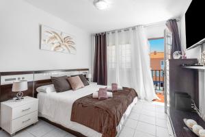 a bedroom with a large bed and a balcony at Casa Brisas De Candelaria in Candelaria