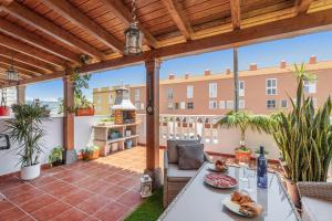 an outdoor patio with a wooden pergola at Casa Brisas De Candelaria in Candelaria