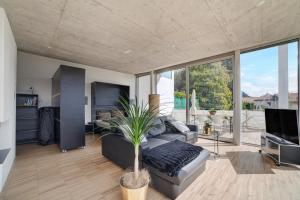 a living room with a couch and a tv at Villa Alvarium Eins in Schenna