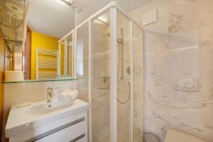a white bathroom with a shower and a sink at Villa Alvarium Eins in Schenna +23 photos