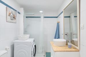 a white bathroom with a washing machine and a sink at Vistamar in Puerto del Carmen +14 photos