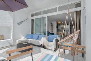 a living room with a couch and a swing at Vistamar in Puerto del Carmen