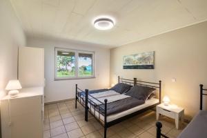 a bedroom with a bed and a window at mit Wintergarten nah Moviepark in Bottrop