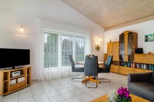 a living room with a table and a tv at Ferienwohnungen Böhme in Konstanz