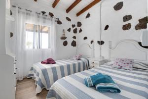 two beds in a room with white walls at Ca Lajares in Lajares