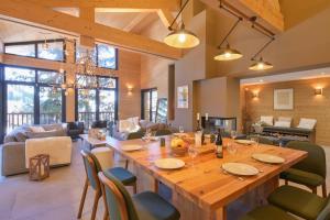 a large wooden table and chairs in a living room at Chalet avec Piscine La Plagne in La Plagne Tarentaise