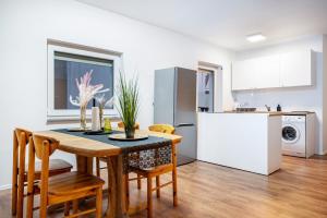a kitchen and dining room with a table and chairs at Cozy Ground Floor Apartment in Bremen +14 photos