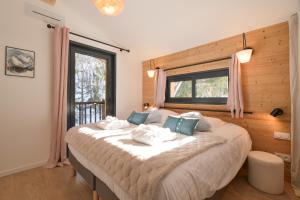 a bedroom with a large bed with a window at Chalet avec Piscine La Plagne in La Plagne Tarentaise +31 photos