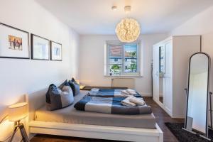 a bedroom with a bed and a chandelier at Ferienwohnungen Neuseenland in Rötha