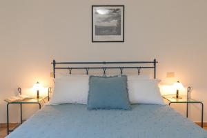 a bedroom with a bed with two side tables at Podere Nuti - 3 Vallino in Cecina +26 photos