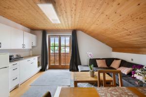 a kitchen and living room with a couch and a table at Ferienwohnung Dorfidyll in Jesenwang