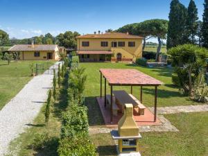 a backyard with a picnic table and a house at Podere Nuti - 3 Vallino in Cecina