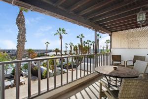 a balcony with a table and chairs and palm trees at Puerto Chico 1 in Playa Blanca