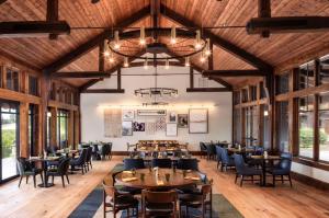 a dining room with tables and chairs and a chandelier at 18221-2 Forestbrook Loop in Sunriver