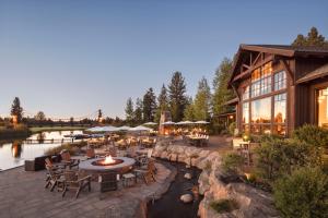 a restaurant with tables and chairs next to a river at 18221-2 Forestbrook Loop in Sunriver