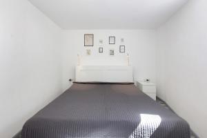 a bed in a room with white walls at Villa Black Forest in Adelhausen