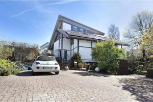 a white car parked in front of a house at Villa Black Forest in Adelhausen