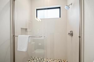 a bathroom with a shower with a glass door at 18221-2 Forestbrook Loop in Sunriver +19 photos