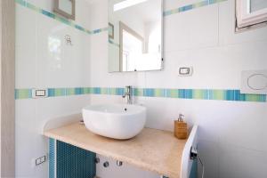 a bathroom with a white sink and a mirror at Villa Massa depandance in Polignano a Mare