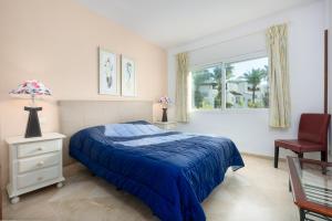 a bedroom with a bed and a chair and a window at Apartamento de lujo a 30m playa in Estepona +27 photos