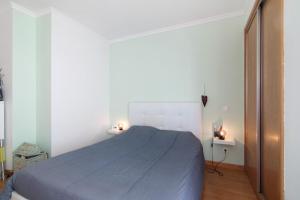 a bedroom with a bed and two lights on the wall at Sunset House Algarve in Faro