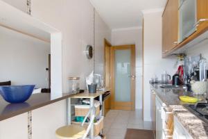a kitchen with white walls and a counter top at Sunset House Algarve in Faro