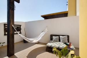 a hammock in a room with a bedroom at Sunset House Algarve in Faro +10 photos