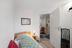 a bedroom with a bed and a door leading to a hallway at Fewo Weber in Sankt Ingbert