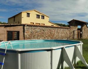 a swimming pool in front of a house at Can Llevorer in Caldes de Montbui