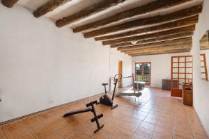 a gym with two exercise bikes in a room at Can Llevorer in Caldes de Montbui