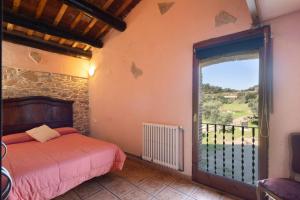 a bedroom with a bed and a large window at Can Llevorer in Caldes de Montbui +35 photos