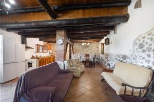 a living room with a couch and a kitchen at Can Llevorer in Caldes de Montbui