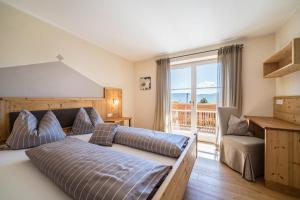 a bedroom with a bed and a balcony at Alber Ferienwohnung Mürri in Verano