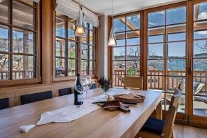 a dining room with a table with a bunch of windows at Alber Ferienwohnung Mürri in Verano