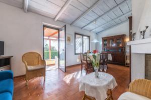 a living room with a table with flowers on it at Casa Luisella in Costa Rei