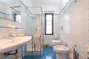 a bathroom with a sink and a toilet and a shower at Casa Luisella in Costa Rei +27 photos