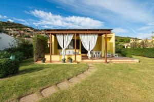 a house with a gazebo in a yard at Casa Luisella in Costa Rei