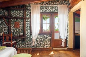 a bedroom with a bed and a window at Casa Balcón - Sólo Familias in Los Caños de Meca +18 photos