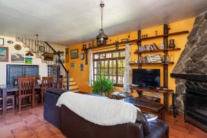 a living room with a couch and a fireplace at Casa Balcón - Sólo Familias in Los Caños de Meca