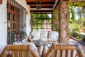 a living room with a couch on a patio at Casa Balcón - Sólo Familias in Los Caños de Meca