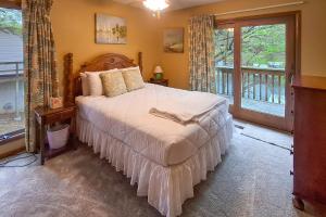 a bedroom with a large bed and a window at Boat Dock! Lakefront Group Getaway in Eldon in Eldon