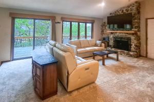 a living room with a couch and a fireplace at Boat Dock! Lakefront Group Getaway in Eldon in Eldon
