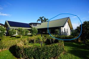 a house with a blue circle in front of it at Riverview Retreat in Kerikeri