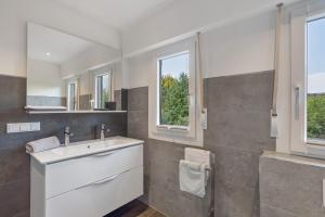 a bathroom with a sink and a mirror at Haus Marianne in Arnsberg