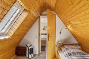 a small attic bedroom with a bed and a window at Haus Marianne in Arnsberg