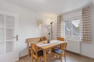 a dining room with a table and chairs and a window at Haus Marianne in Arnsberg +17 photos