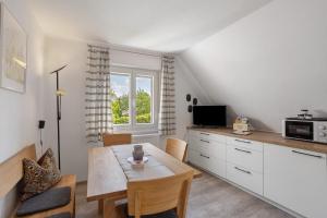 a kitchen and dining room with a table and a window at Haus Marianne in Arnsberg