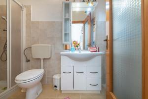 a bathroom with a toilet and a sink and a shower at Monolocale Il Girasole in Villaputzu