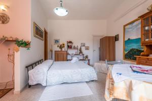 a bedroom with two beds in a room at Monolocale Il Girasole in Villaputzu